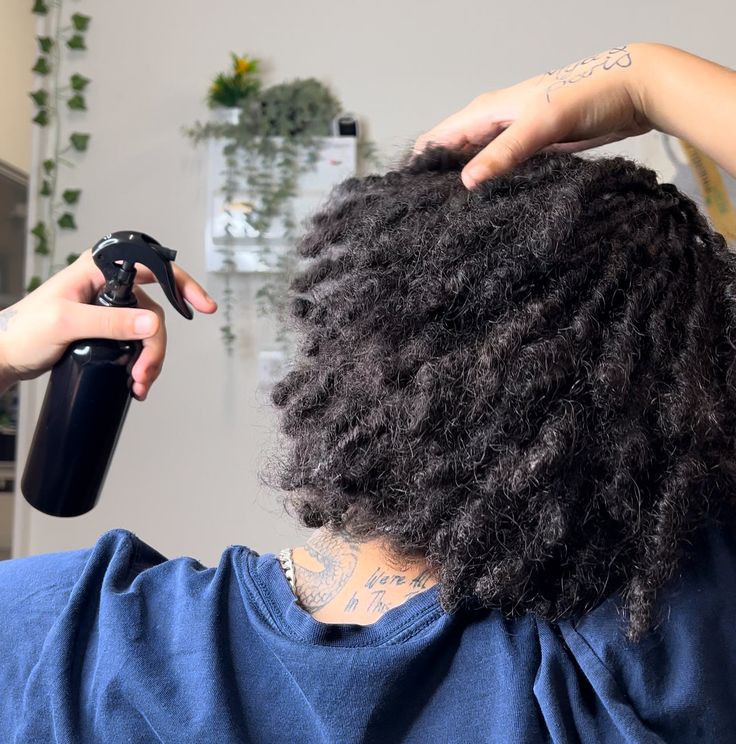 Lightweight moisture being applied to natural starter locs