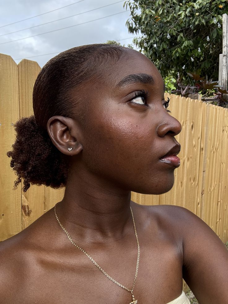 Woman wearing natural 4C hair with softly styled edges