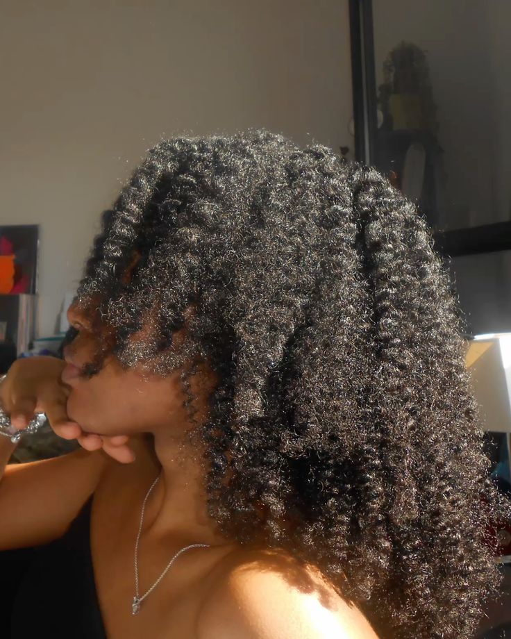 Woman wearing loose natural 4C hair between protective styles