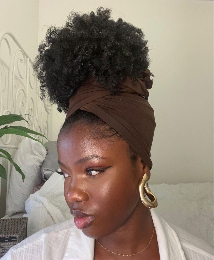 Woman wearing a stylish headwrap over natural hair for rainy day