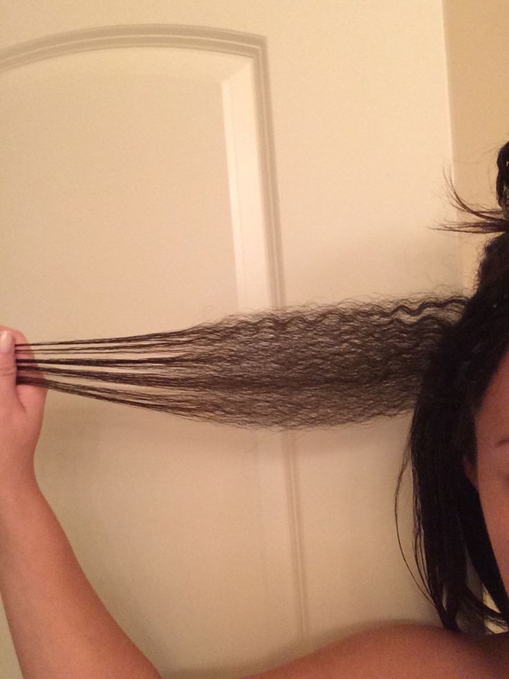 Woman showing natural hair length during a transition