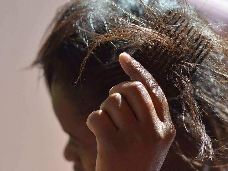 Woman caring for transitioning natural hair to prevent breakage