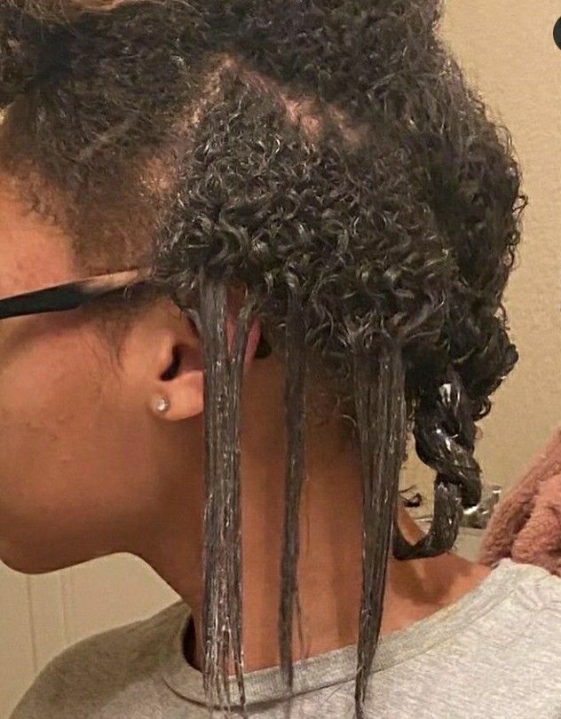 Close-up of natural roots growing from relaxed hair during a transition