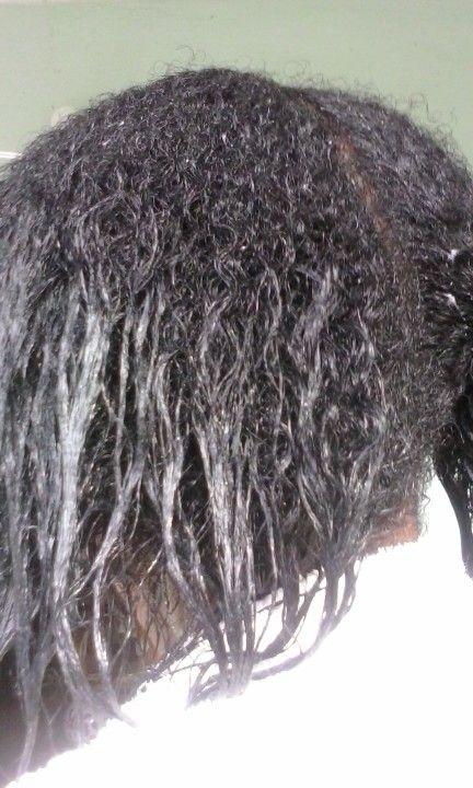 Natural roots and relaxed ends visible on transitioning hair