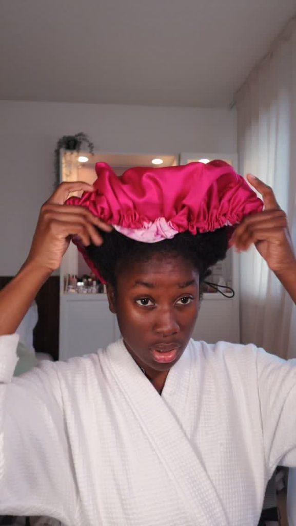 Woman protecting natural 4C hair before bed during fall