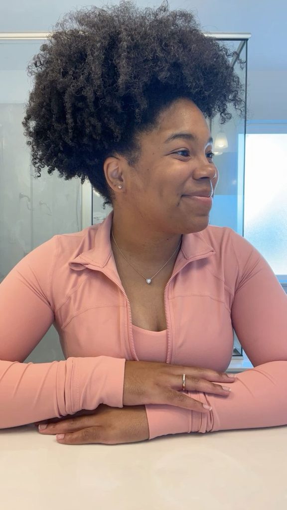 Woman wearing a large oversized puff on natural 4C hair