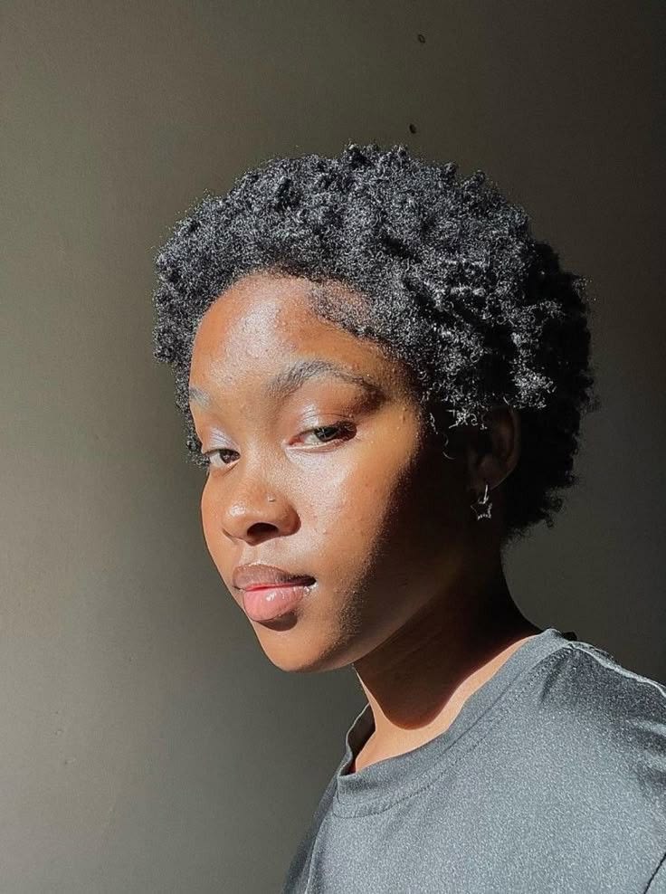 Woman gradually cutting relaxed ends during a natural hair transition