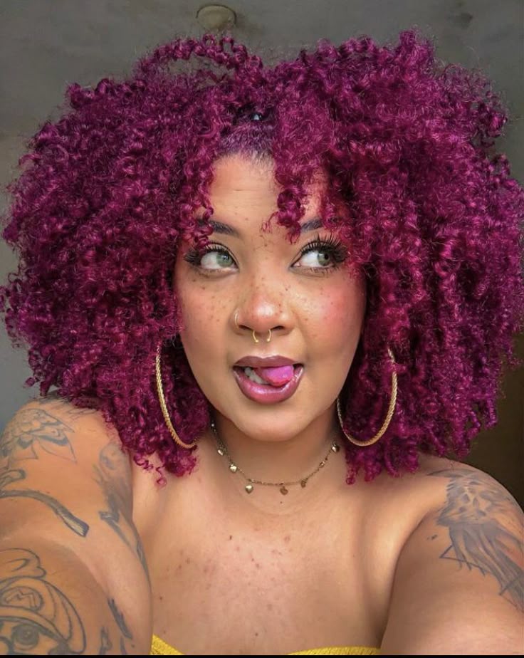Black woman wearing pink and magenta natural hair color