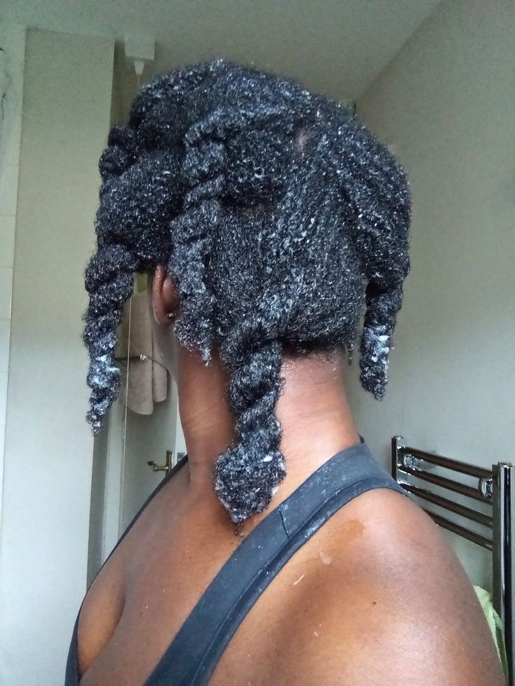 Woman caring for fully natural 4C hair after transitioning