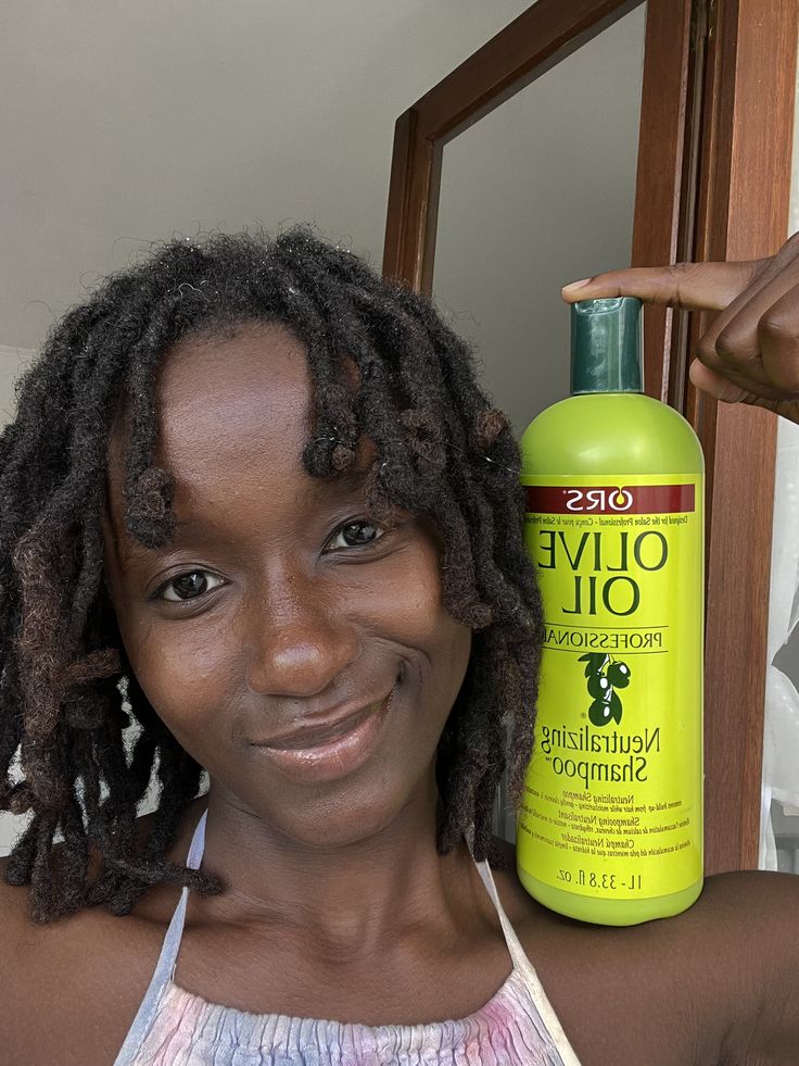 Hair products beside natural locs illustrating product buildup concerns