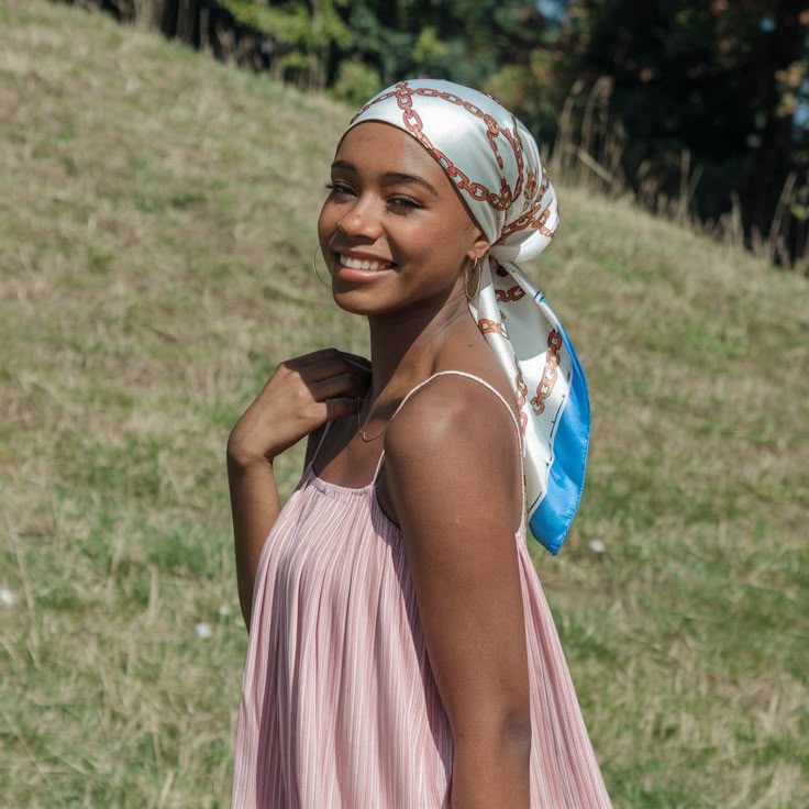 Woman protecting natural 4C hair with a scarf outdoors