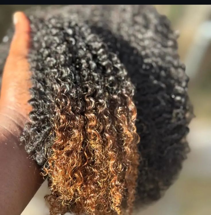 Woman protecting the ends of colored 4C natural hair