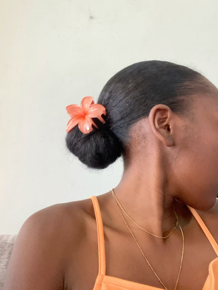 Woman wearing a protective low bun with a hair accessory