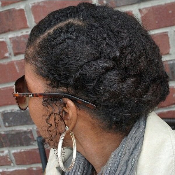 Woman wearing a low-tension protective style while transitioning to natural hair