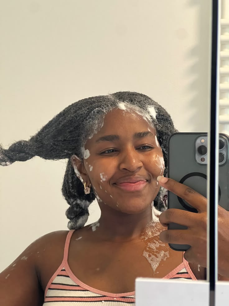 Woman following a simple rainy season routine for 4C hair