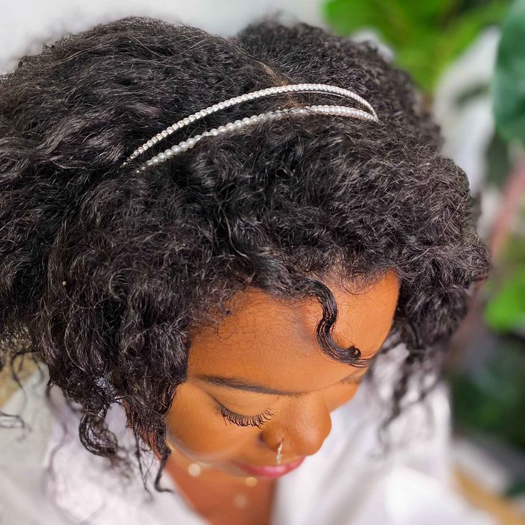 Woman wearing a rhinestone headband with natural hair