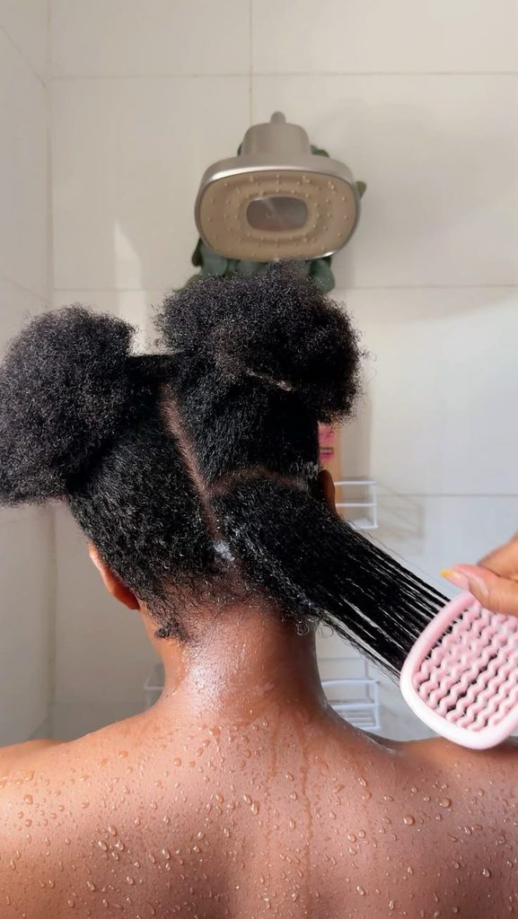 woman detangling her hair smoothly