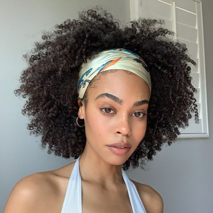 Twist-out hairstyle decorated with a satin ribbon