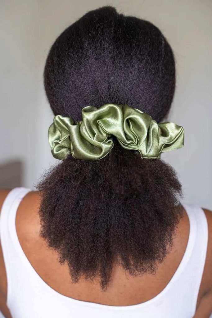 Natural hair puff secured with a satin scrunchie