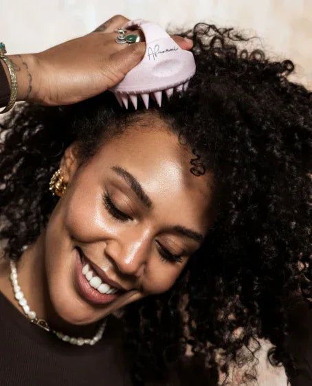 Woman gently massaging her scalp while caring for natural hair