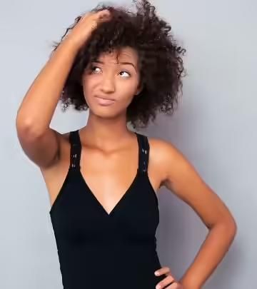 a woman scratching her scalp