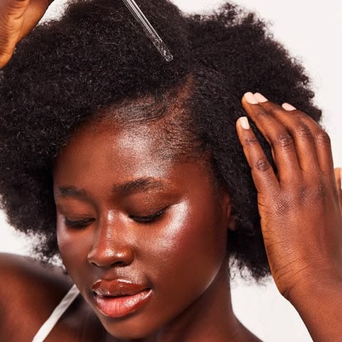 a woman sealing in moisture with hair oil
