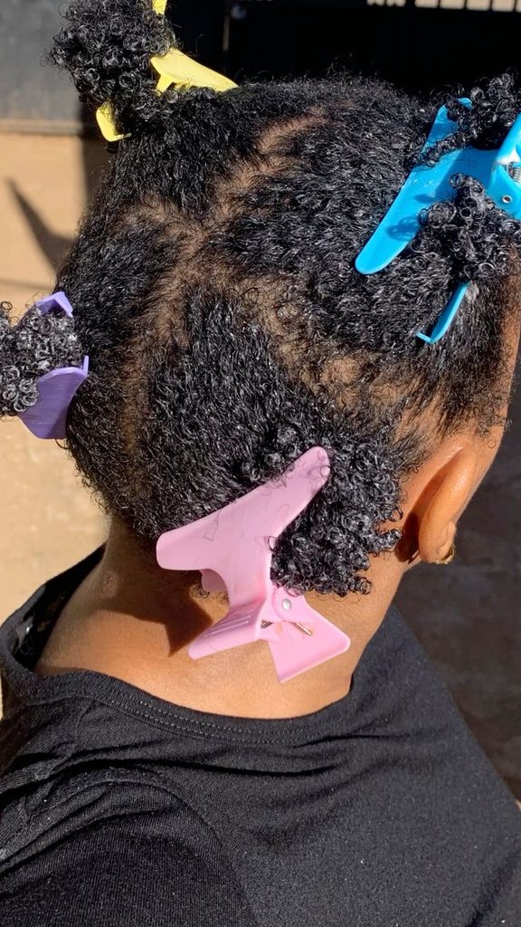 Natural 4C hair divided into sections during wash day
