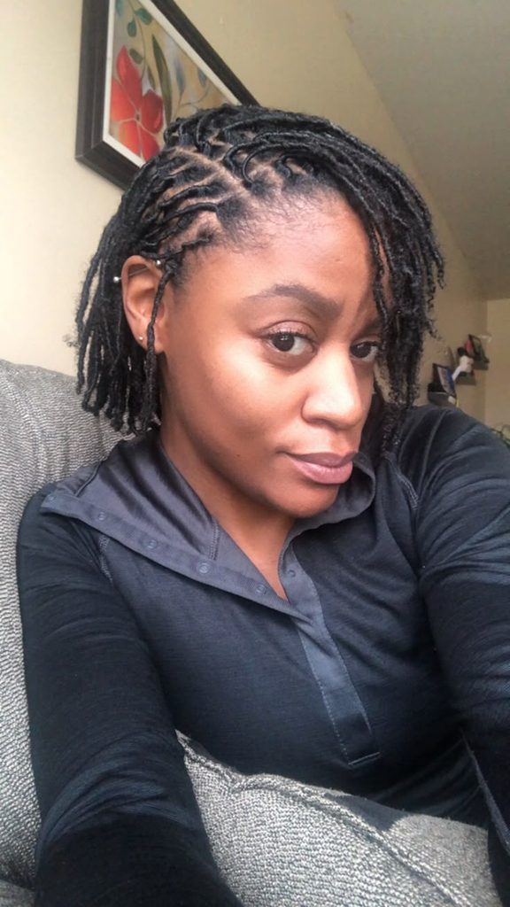 Short 4C starter locs styled with a simple side part