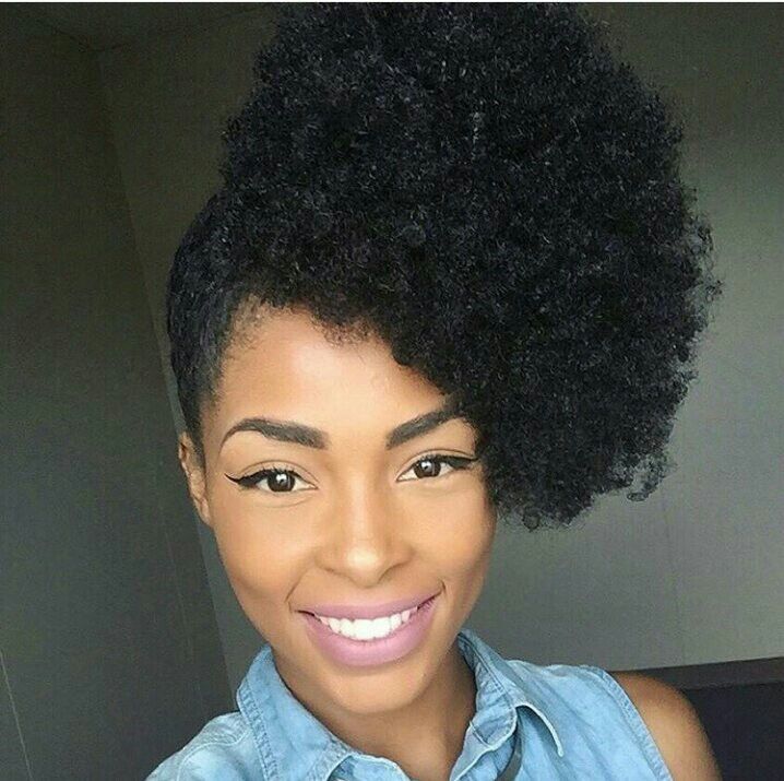 Woman with a side puff hairstyle on natural 4C hair