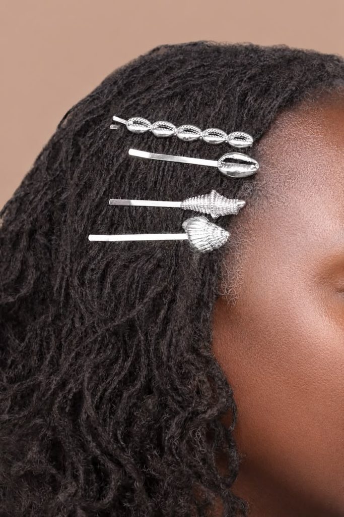 Woman wearing silver hair pins in a natural hairstyle