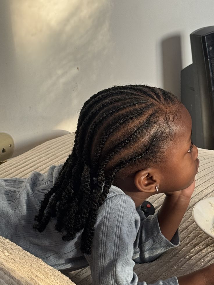Black child wearing simple cornrows protective styles in natural hair