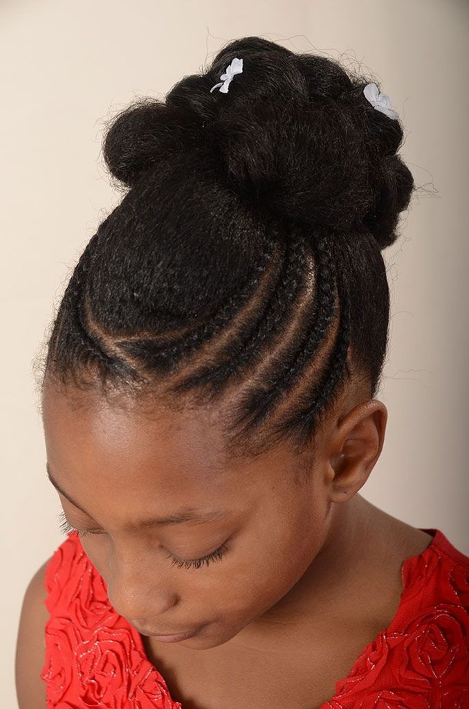 Black child wearing a simple plaited natural hair updo protective styles