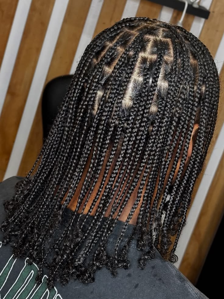Woman with small neat box braids on natural hair