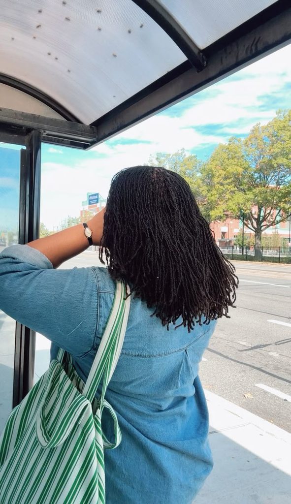 Woman confidently wearing healthy microlocs as part of her natural hair journey