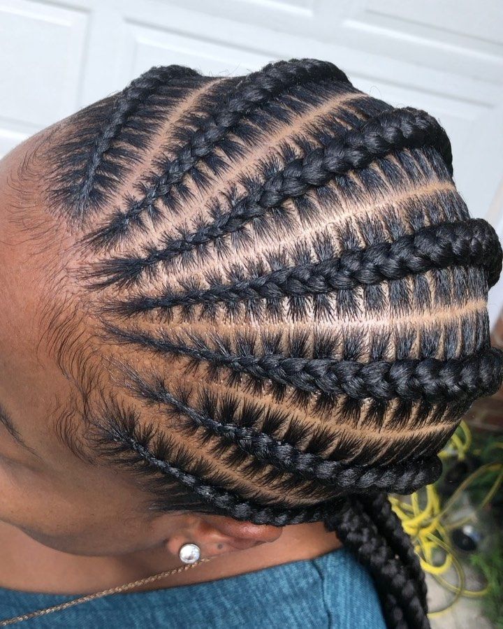 Woman wearing neat stitch braids with precise sections