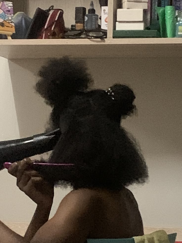 black woman stretching her 4c hair