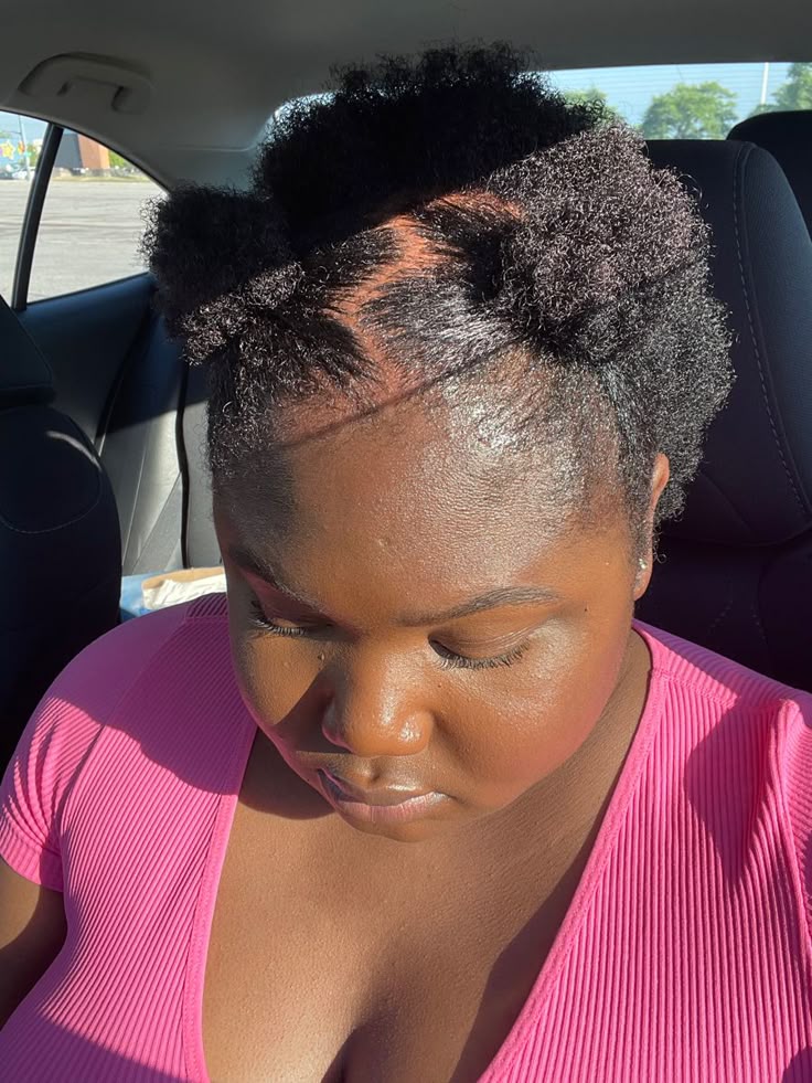 Woman styling short natural 4C hair after a big chop