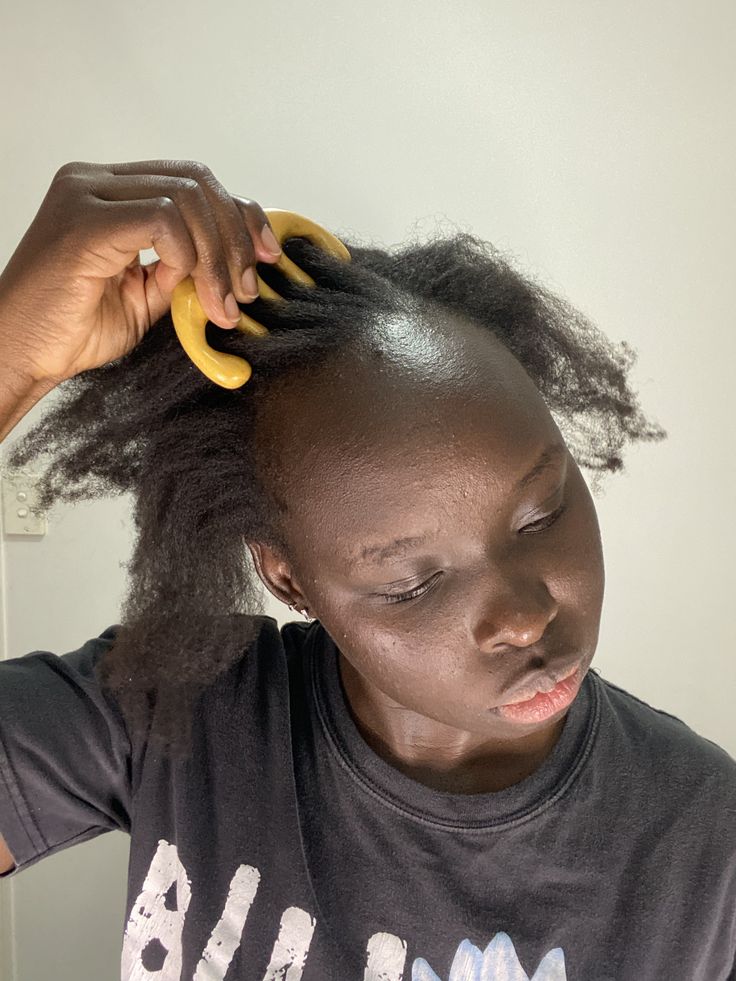 Woman gently caring for her scalp as part of a summer hair routine