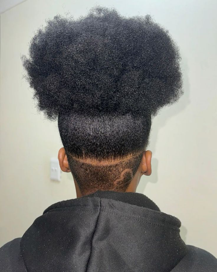 Tapered natural 4C haircut styled into a puff