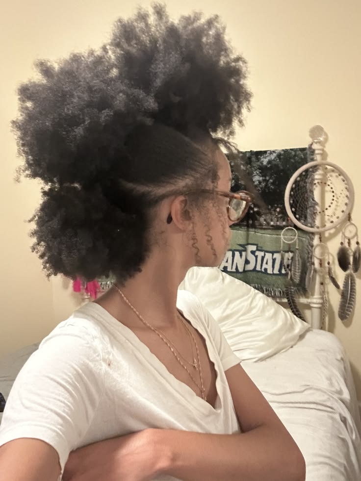 Woman wearing three mini puff hairstyles on natural hair
