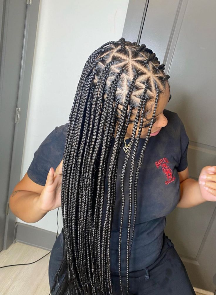Woman with triangle-part box braids on natural hair