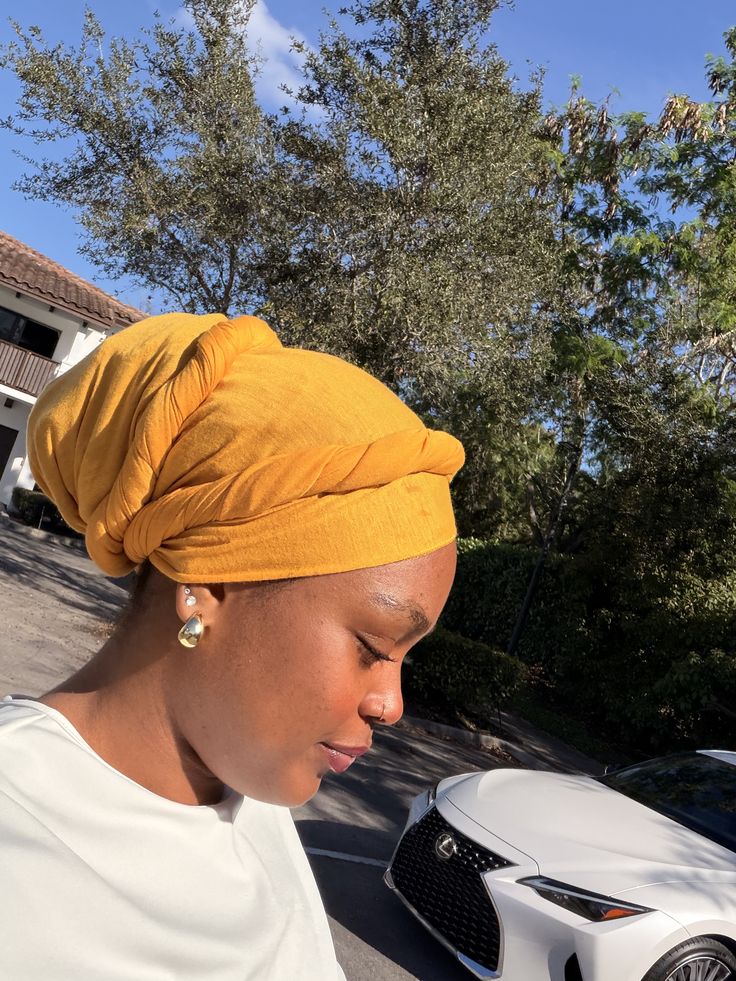 Woman wearing a turban headwrap with natural hair