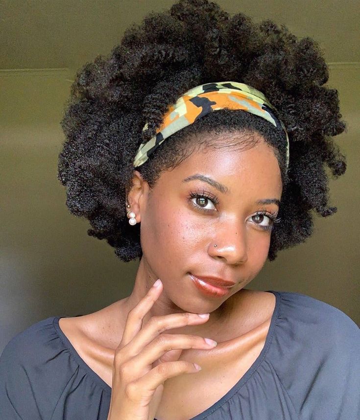 Twist-out natural 4C hair styled into a puff with a headband