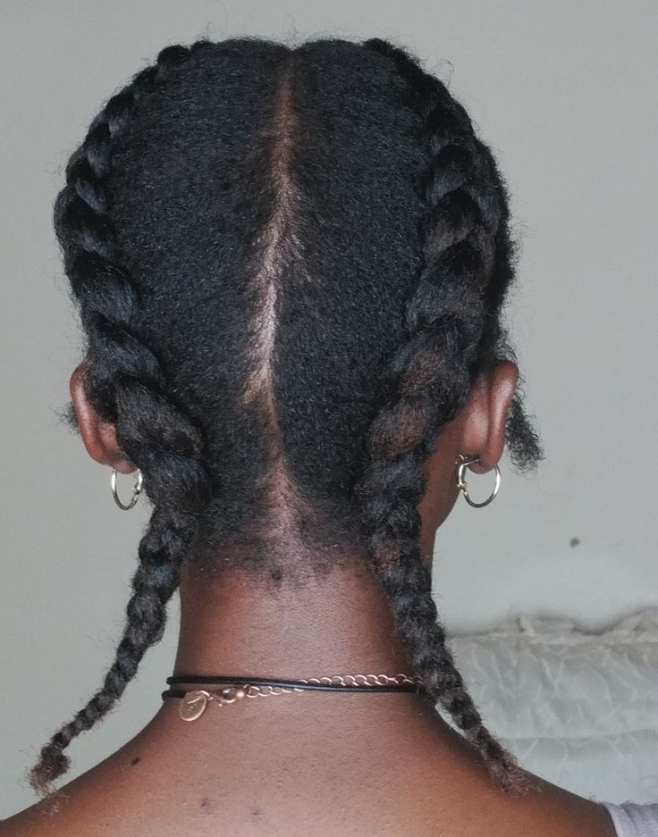 Woman wearing two Dutch braids on natural 4C hair