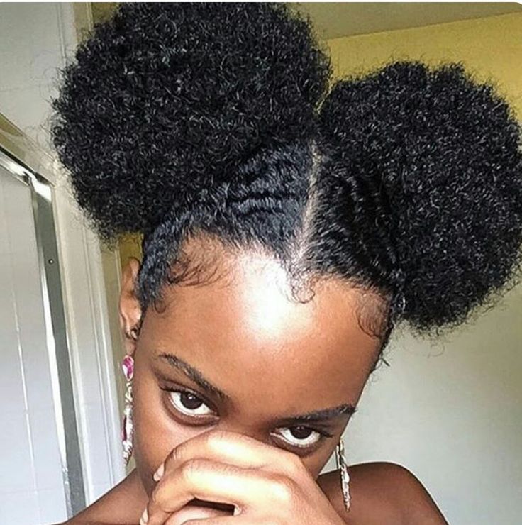 Woman wearing two mini puffs on short natural 4C hair