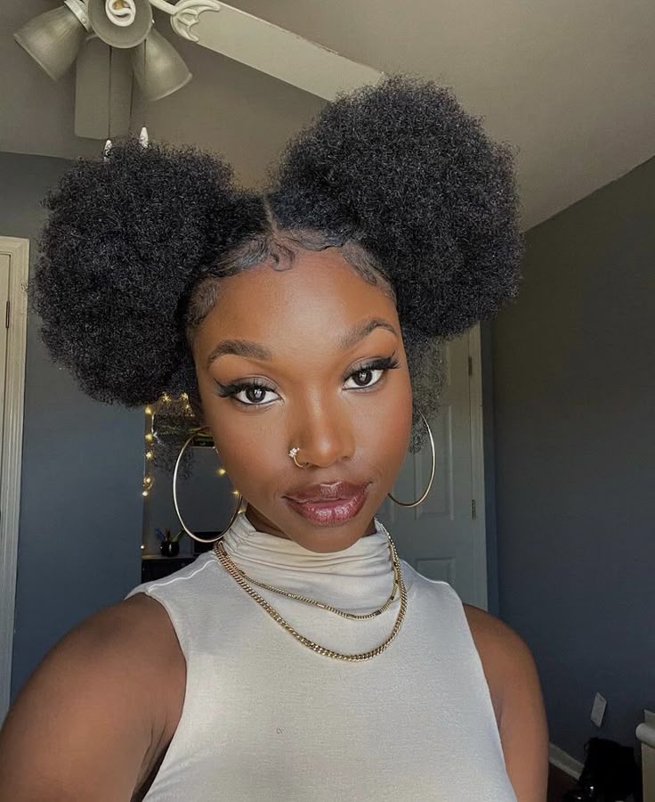 Two side puff hairstyles with a center part on 4C ha