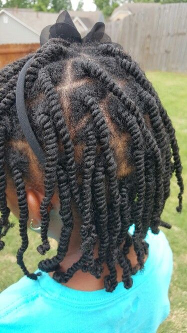 Young child wearing neat two-strand twists as a protective natural hairstyle