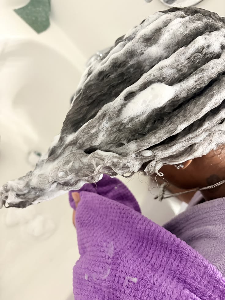 Woman washing transitioning hair during wash day