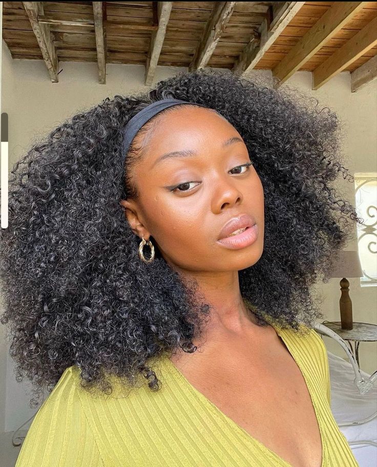 Woman wearing a wig while transitioning from relaxed to natural hair
