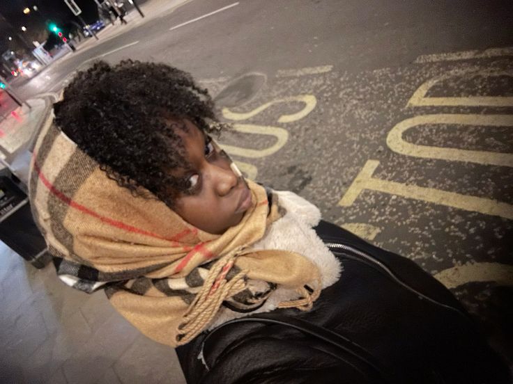 Woman protecting natural 4C hair from windy fall weather